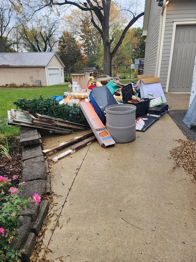 Dumpster being loaded with debris for Estate Cleanout Dumpster Rental in Wallington